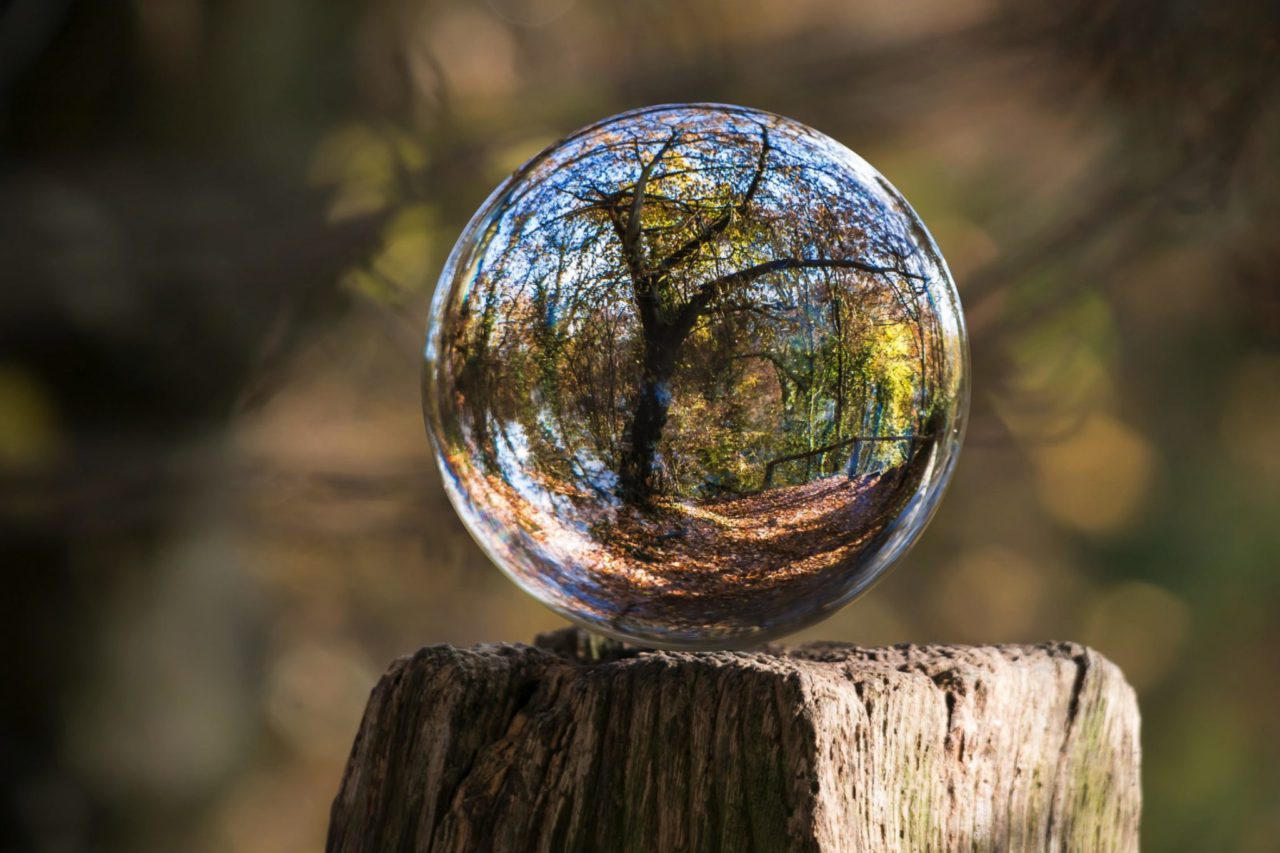 glass ball sitting on top of fence post