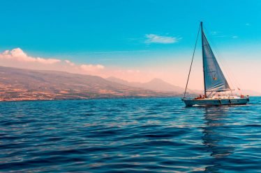 Sailboat on the water with the clouds in the background